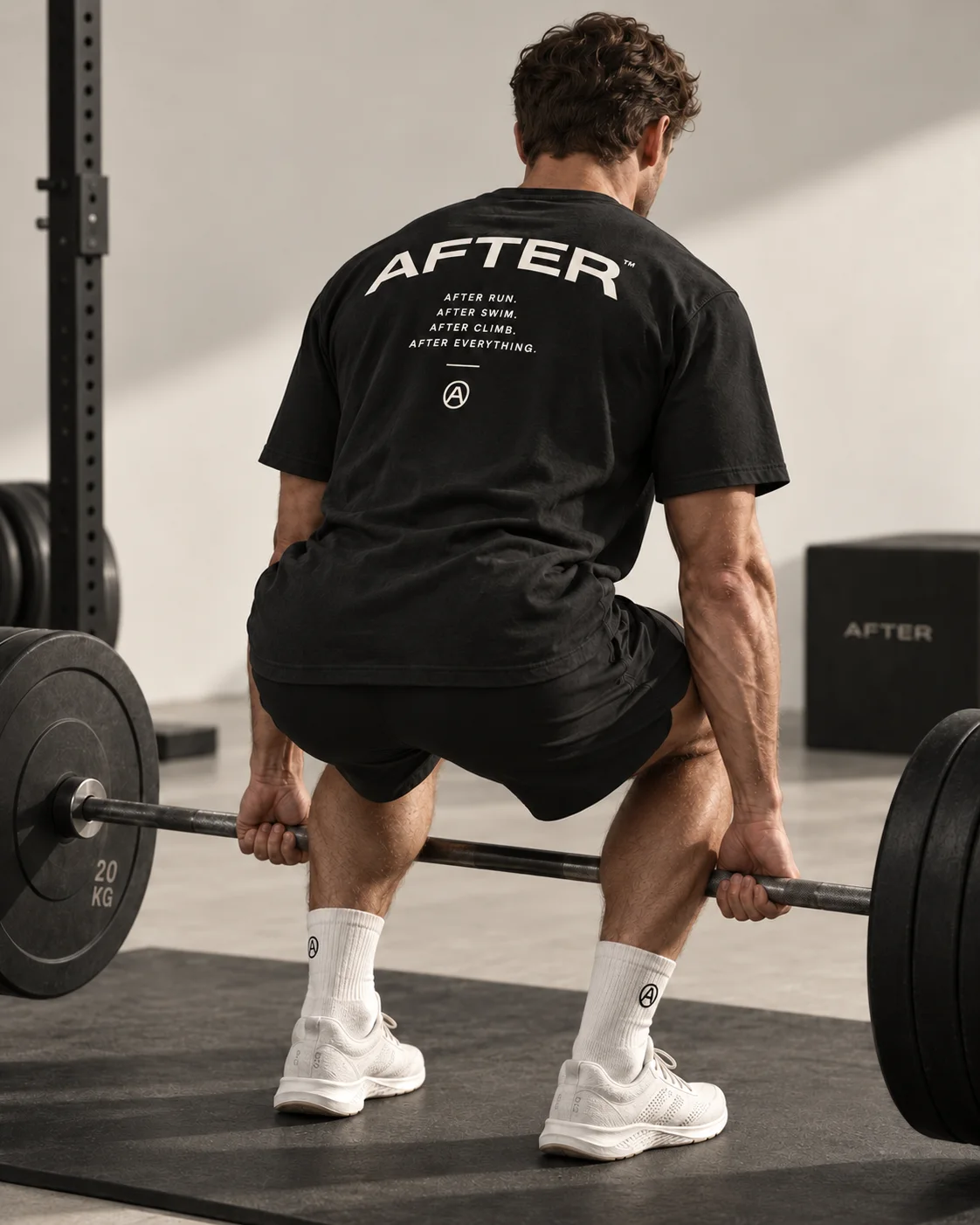 Lifter wearing an AFTER tee in an athletic campaign portrait